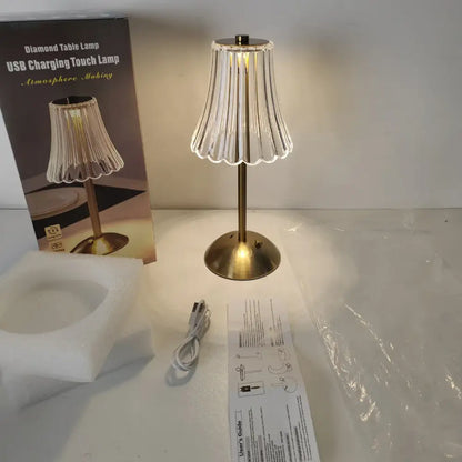 Brass-finished crystal retro table lamp with clear fluted glass shade emitting warm light for luxurious bedside use