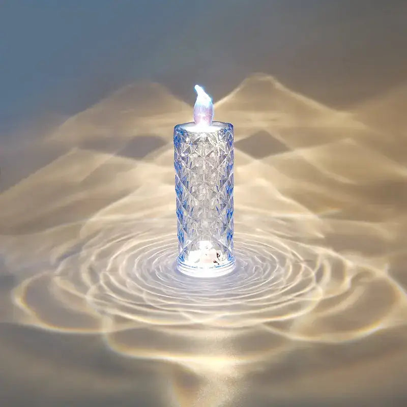 A clear faceted glass decorbites crystal rose night light with a glowing blue flame for bedroom use