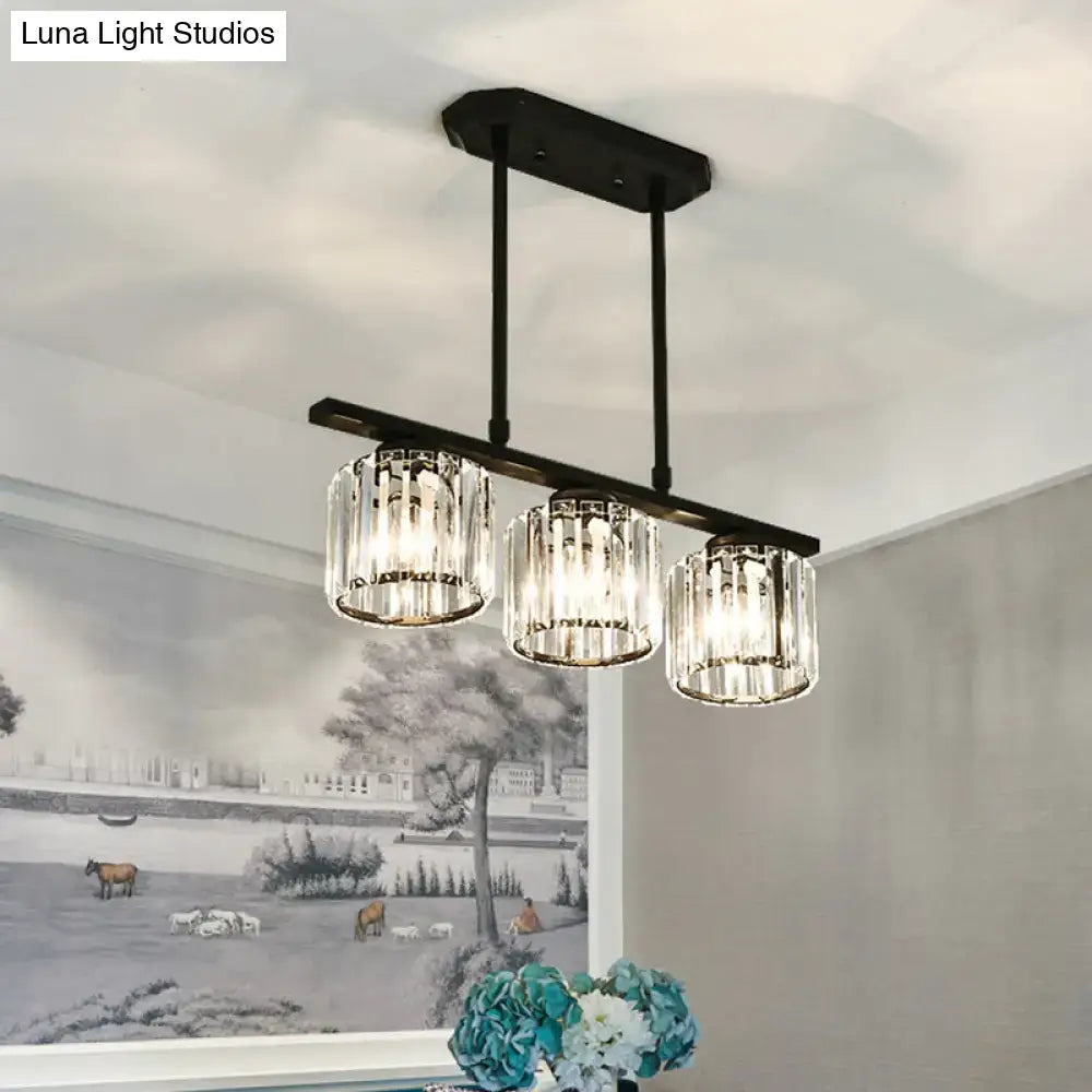 Black metal bar pendant light with three cylindrical crystal shade glass fixtures for dining room island lighting