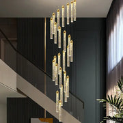 DecorBites™ crystal staircase chandelier with gold-tipped cylindrical glass tubes filled with sparkling particles for modern interiors