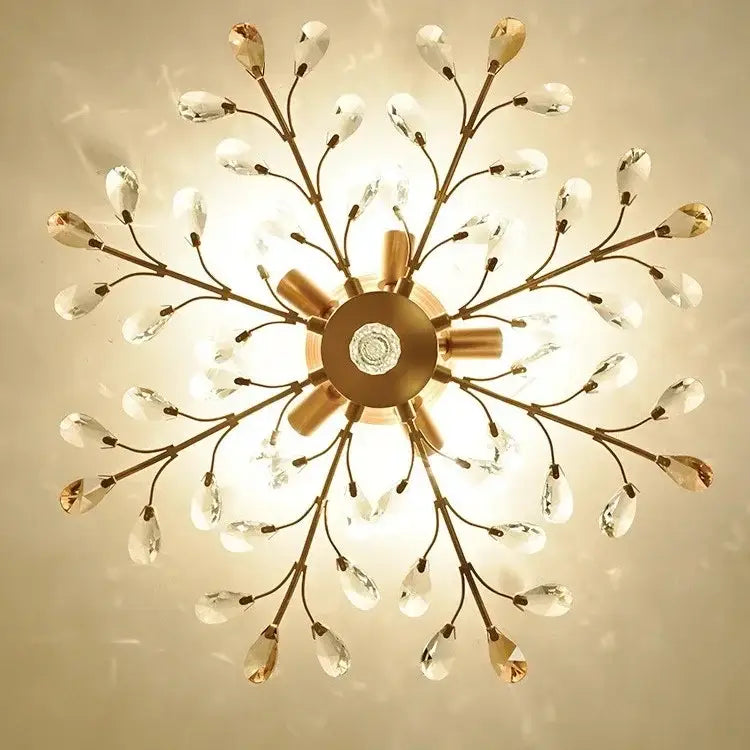 Gold-toned decorbites crystal tree chandelier with delicate crystal teardrop pendants and central circular fixture