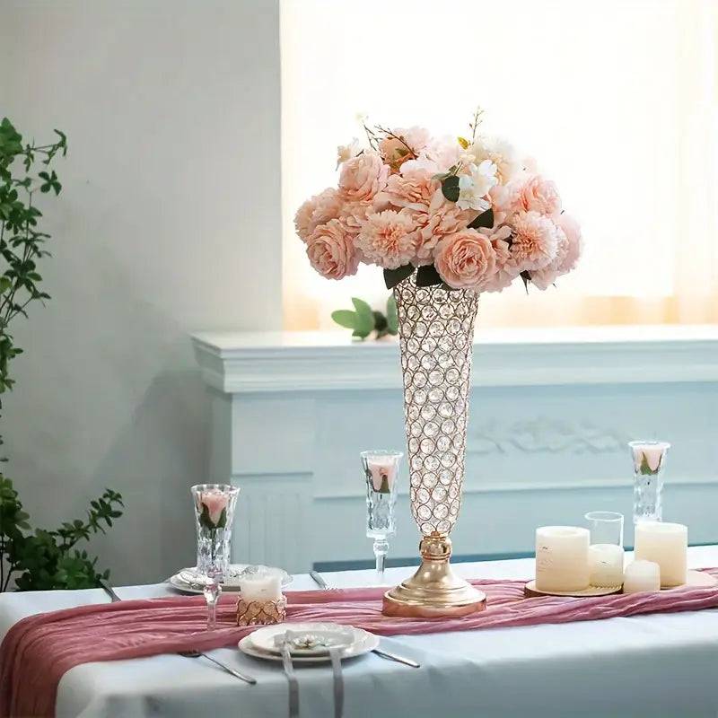 Tall crystal vase with gold base holding pink and white roses for dining tables and home decor by decorbites™