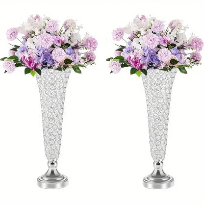 Two tall crystal vases with silver bases and pink purple white artificial flowers for dining tables home decor