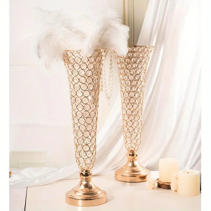 Two elegant gold-toned crystal vases with beaded circular pattern and feather accents for dining tables and home decor