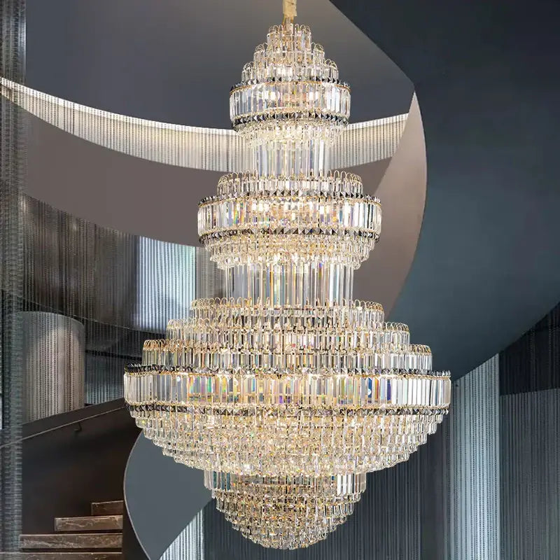 A multi-tiered decorbites crystal villa chandelier with clear faceted crystals and gold-toned metal for living room lighting