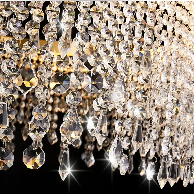 A dazzling gold decorbites crystal waterfall chandelier with cascading faceted beads for dining room lighting
