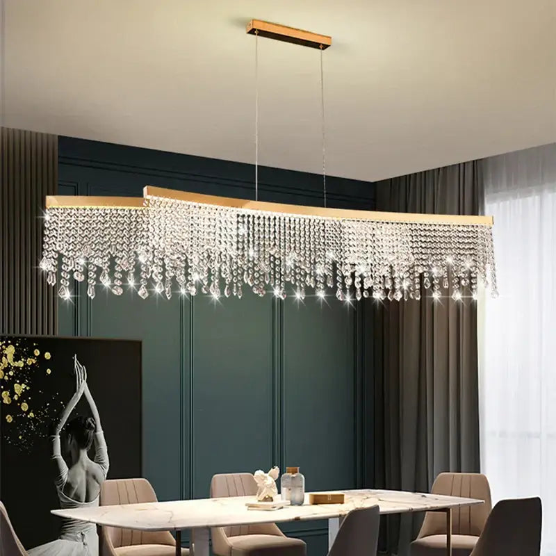A modern decorbites crystal waterfall chandelier with a gold frame and clear crystal droplets for dining room use
