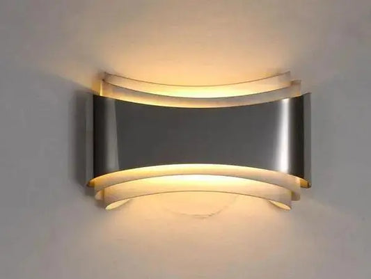 Decorbites™ curved modern wall sconce in brushed stainless steel with layered design and warm led lighting