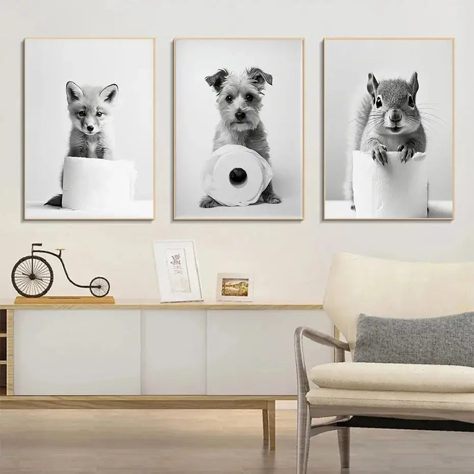 Three framed black and white cute animals canvas wall art featuring a fox puppy and squirrel on toilet paper rolls for bathroom decor