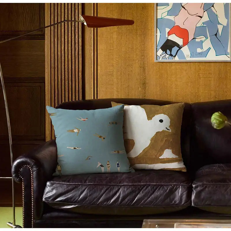 Blue cushion with illustrated swimmers pattern on light blue background in decorbites cute dog printed pillow cover