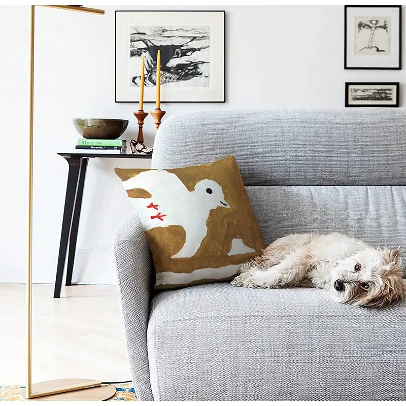 A cozy gray sofa with a decorbites cute dog printed black and white pillow cover featuring an embroidered bird design