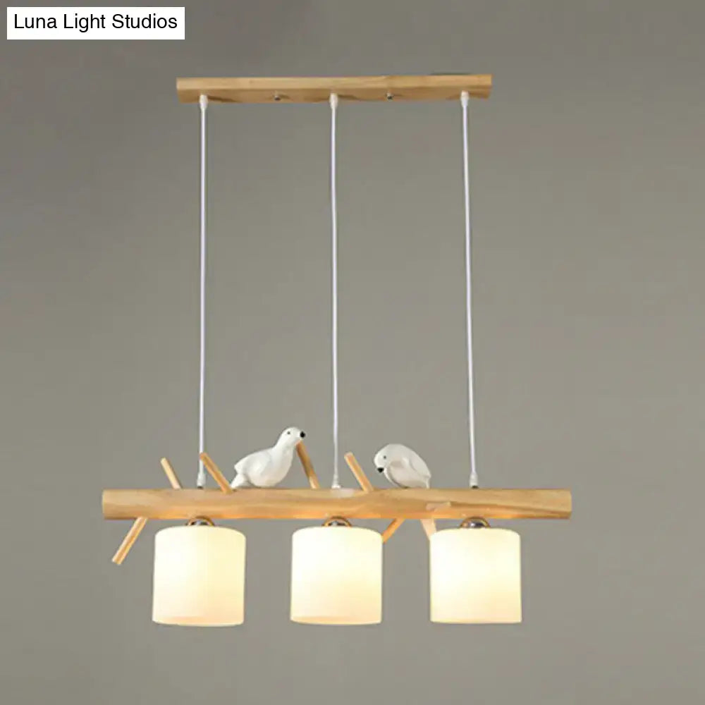 DecorBites™ cylindrical milk glass pendant light with wooden beam and white resin bird deco for country style restaurants