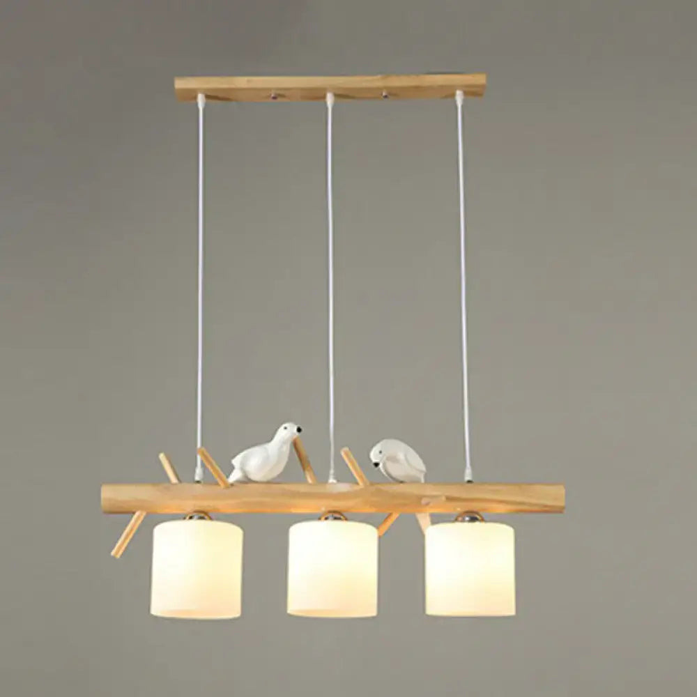 DecorBites™ cylindrical milk glass pendant light with wooden frame and white resin bird deco for country style restaurants