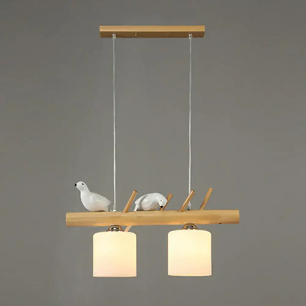 DecorBites™ minimalist wooden pendant light with cylindrical milk glass shades and white resin bird deco for country style restaurants