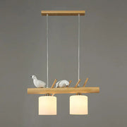 DecorBites™ minimalist wooden pendant light with cylindrical milk glass shades and white resin bird deco for country style restaurants