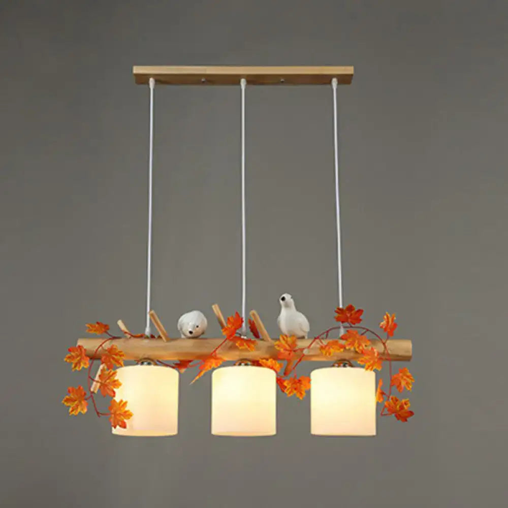 Decorbites™ rustic wooden pendant light with three warm milk glass shades and resin bird deco for country style restaurants