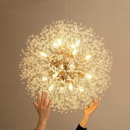 A decorbites dandelion chandelier in gold and crystal with illuminated bulbs for elegant living room lighting