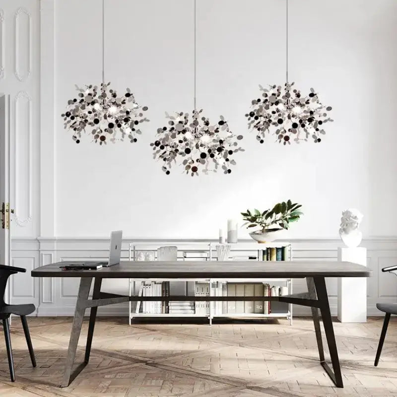 Three modern pendant lights with silver and black leaf-like metalwork for dining room featuring decorbites dandelion chandelier