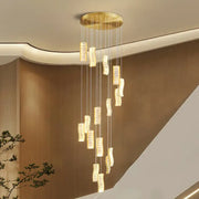Golden circular ceiling fixture with cascading rectangular crystal pendants in decorbites deluxe crystal spiral slinglights pendant