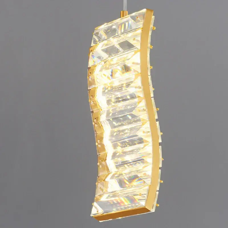 Gold-toned decorbites deluxe crystal pendant light with curved design and faceted crystal panels for dining room illumination