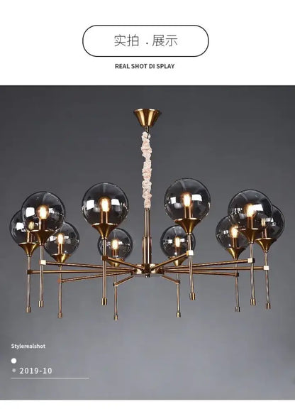 Brass-finished designer metal chandelier with multiple spherical glass globes and twisted rope-like pendant for modern living