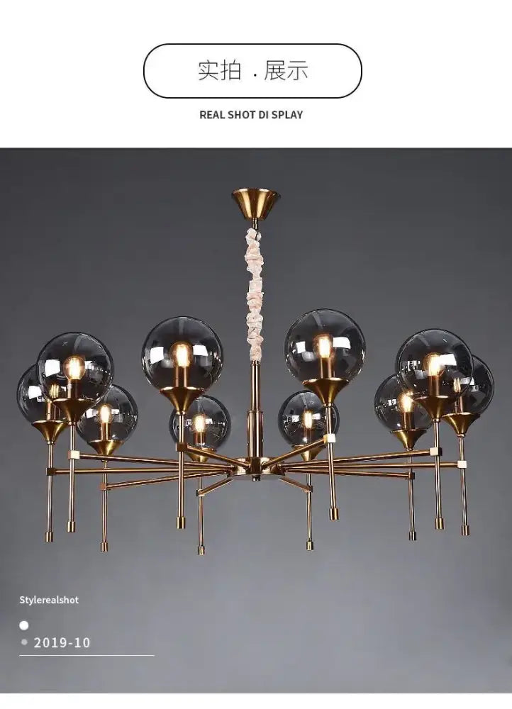 Brass-finished designer metal chandelier with multiple spherical glass globes and twisted rope-like pendant for modern living