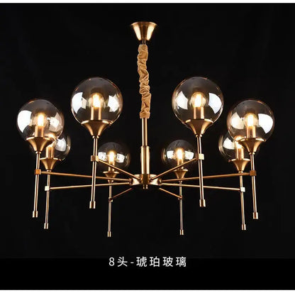 Brass-finished designer metal chandelier with eight spherical glass globe shades for modern living spaces