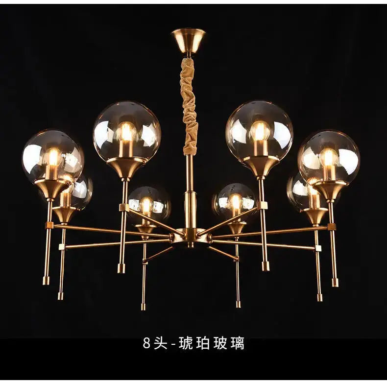 Brass-finished designer metal chandelier with eight spherical glass globe shades for modern living spaces