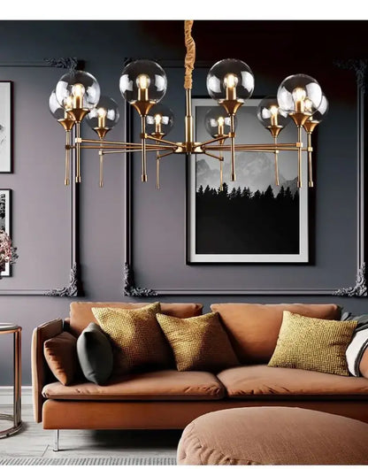 Brass designer metal chandelier with clear glass globe shades for modern living by decorbites