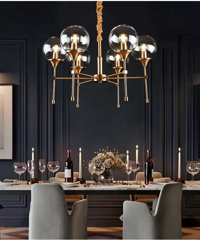 Gold-toned decorbites™ designer metal chandelier with clear glass globe shades for modern living dining areas