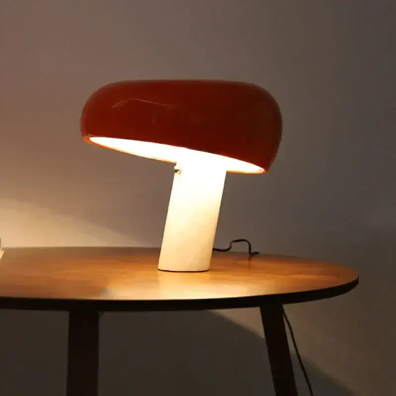 A sleek red glossy designer mushroom lamp with a white cylindrical base from decorbites for study room decor