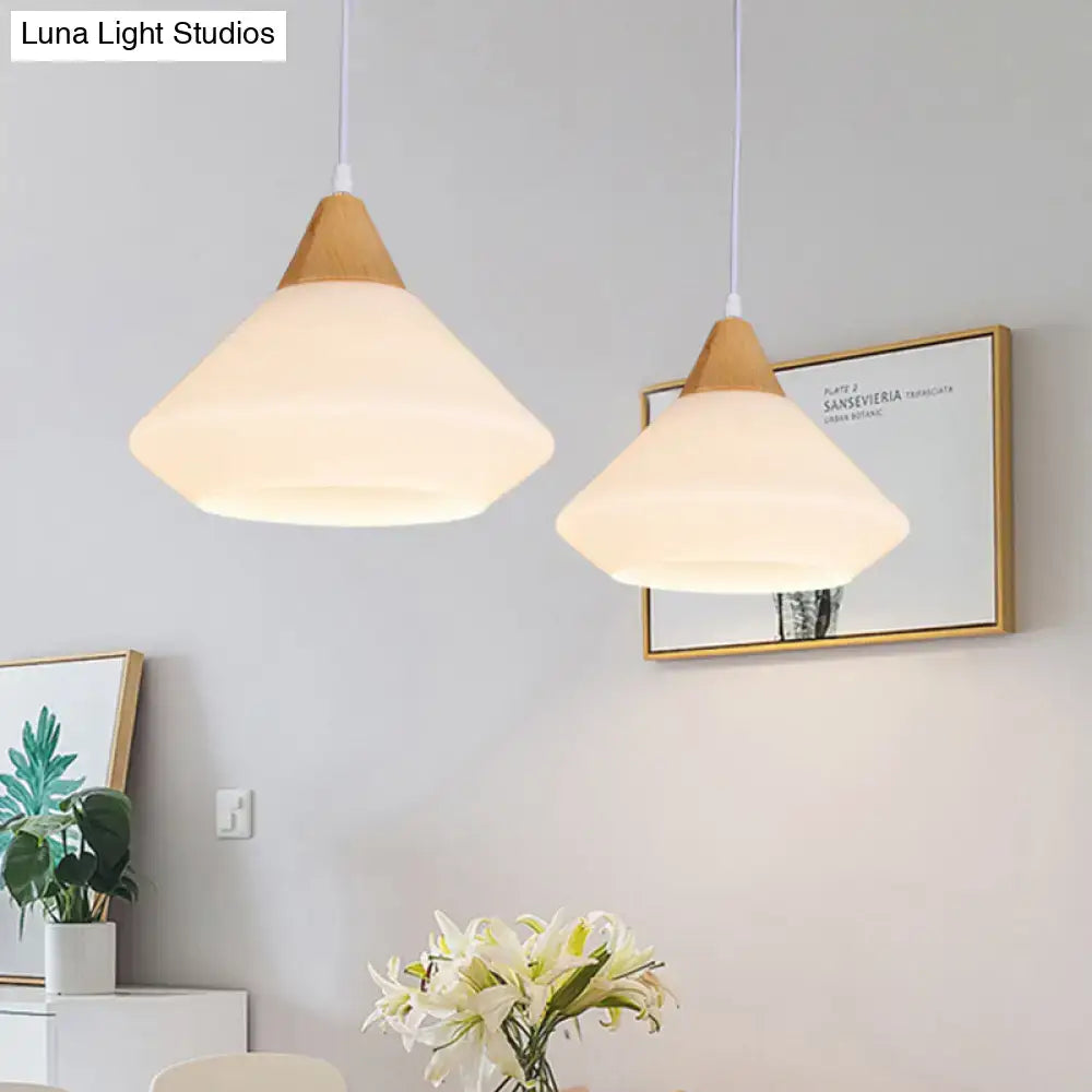 Two modern pendant lights with diamond white glass shades and wood accents for dining room ceiling lighting