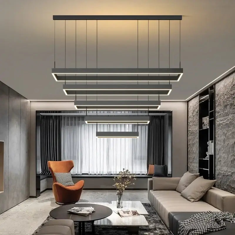 Modern black linear dimmable led ceiling chandelier with illuminated edges hanging above living room by decorbites