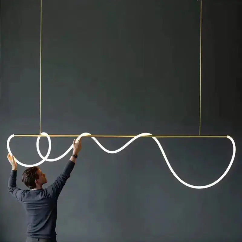 A sleek gold-toned decorbites™ dimmable nordic hose led ceiling chandelier with a glowing white led strip for home decor