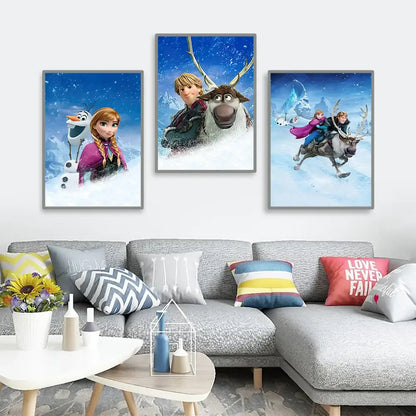 Three framed disney frozen anna and elsa canvas art prints featuring characters on snowy blue backgrounds