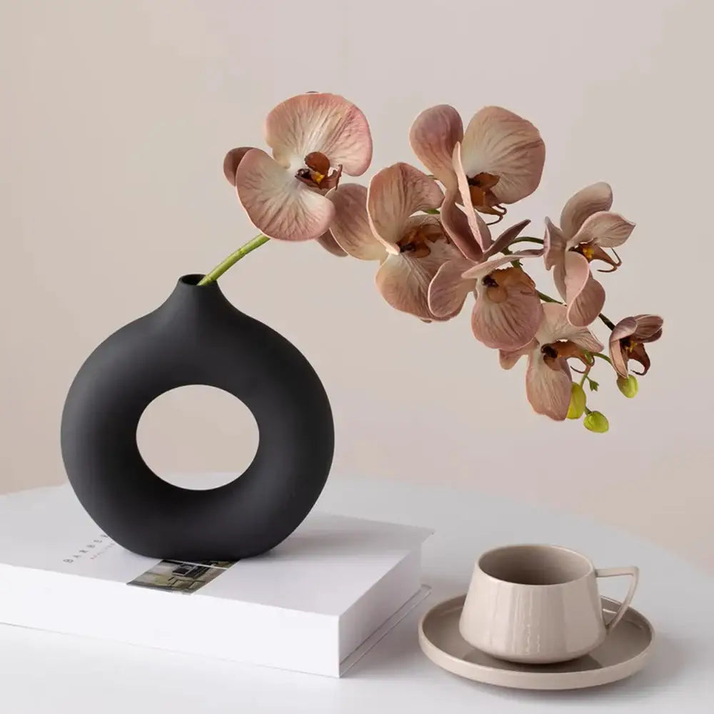 Black matte ceramic donut shape flower vase with circular cutout from DecorBites™ white minimalist collection