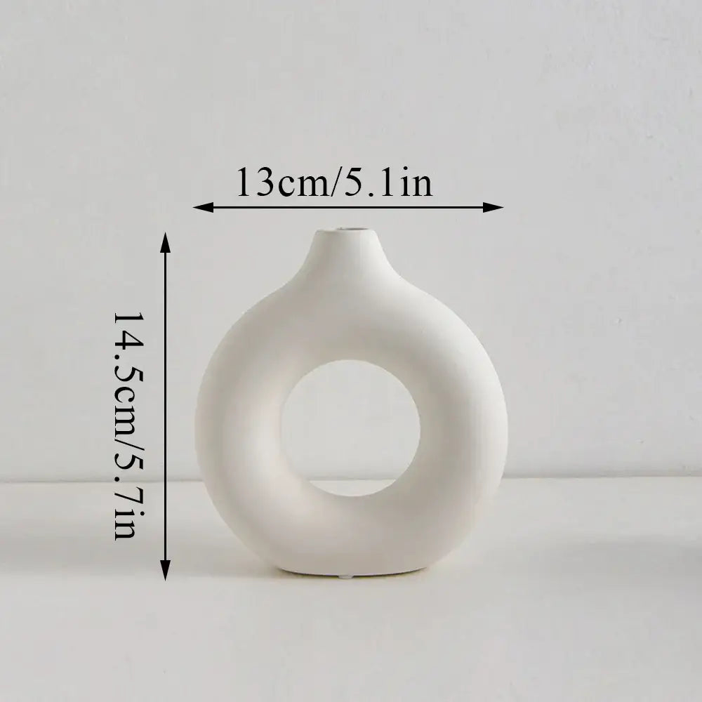DecorBites™ white minimalist ceramic flower vase with a distinctive donut shape hole for decorative display