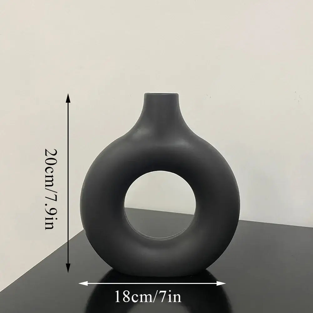 Decorbites™ matte black ceramic donut shape flower vase with minimalist design and central circular hole