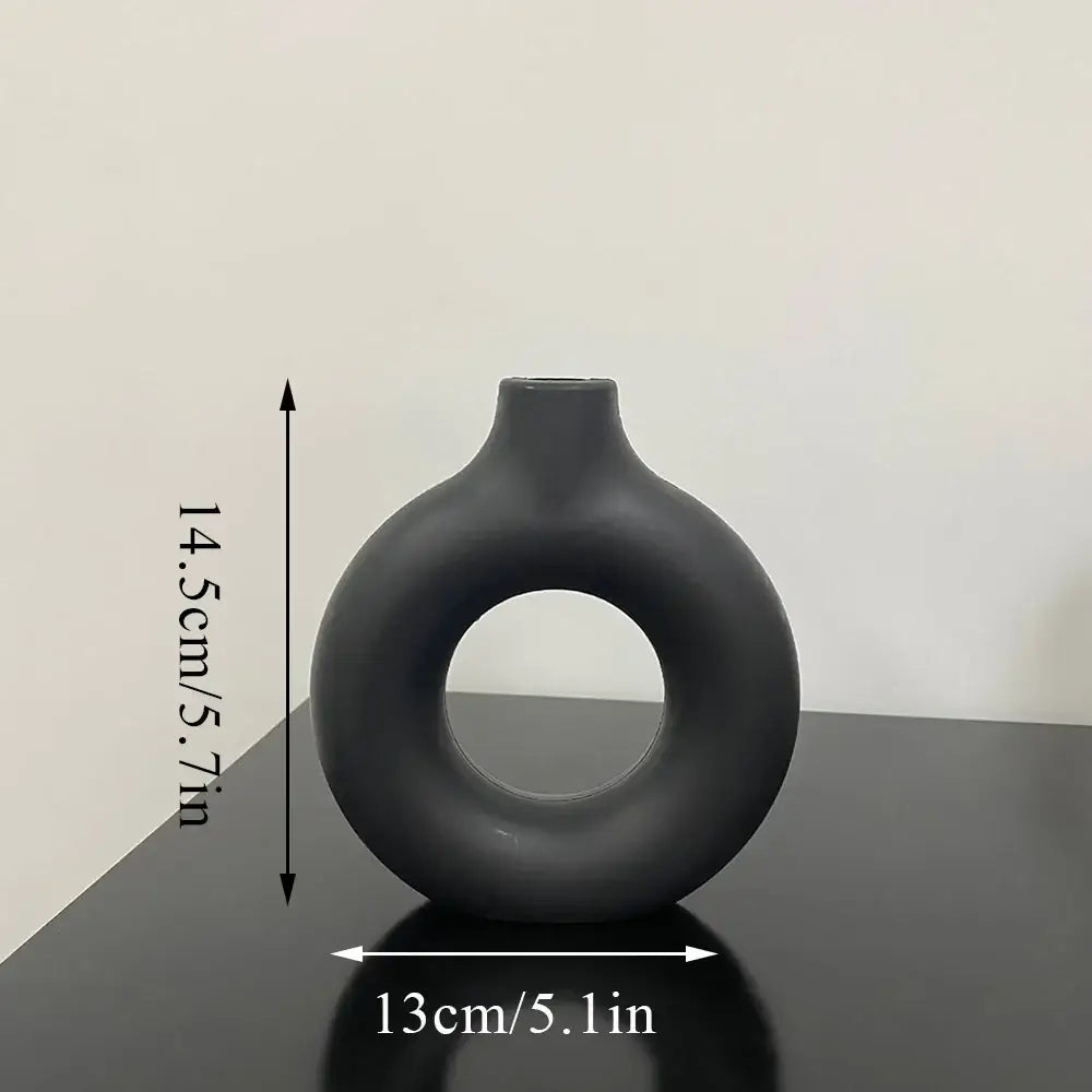 Decorbites™ donut shape flower vase in sleek matte black ceramic with modern minimalist design and narrow neck
