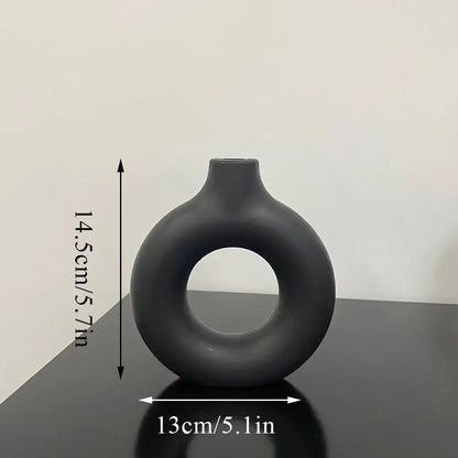 Decorbites™ donut shape flower vase in sleek matte black ceramic with modern minimalist design and narrow neck