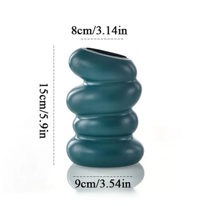 Teal ceramic flower vase with donut shape stacked rounded segments and glossy finish for minimalist decor