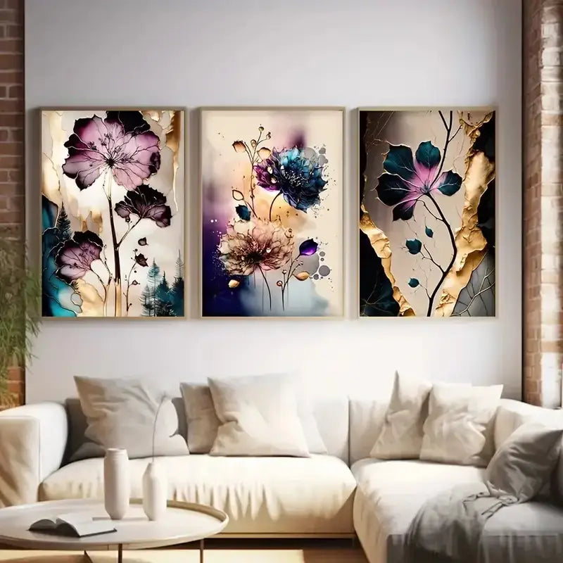 Three framed dreamy flowers canvas posters with vibrant purple blue and gold accents hang above a white sofa