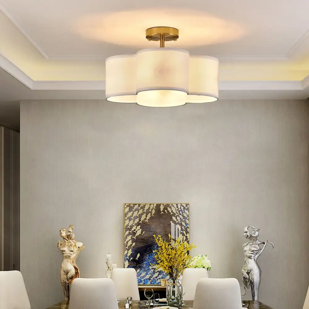 Decorbites elegant 4-light gold ceiling fixture with three off-white cylindrical shades in a cloud-like cluster ceiling light