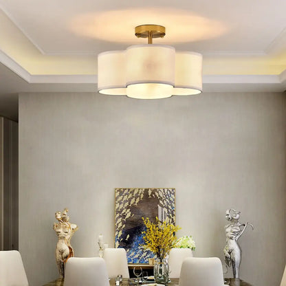 Decorbites elegant 4-light gold ceiling fixture with three off-white cylindrical shades in a cloud-like cluster ceiling light