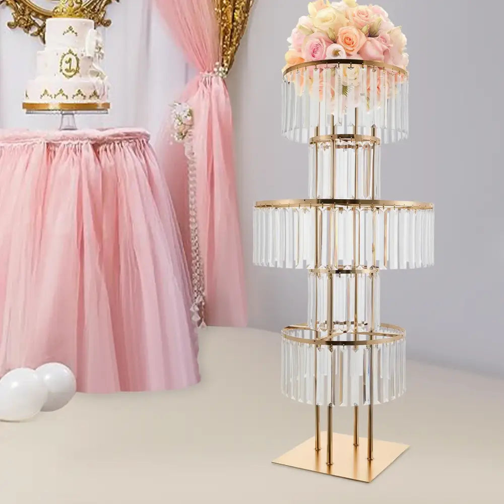 Gold-toned tiered cake flower stand with clear crystal rods and floral arrangement for elegant gold wedding flower display