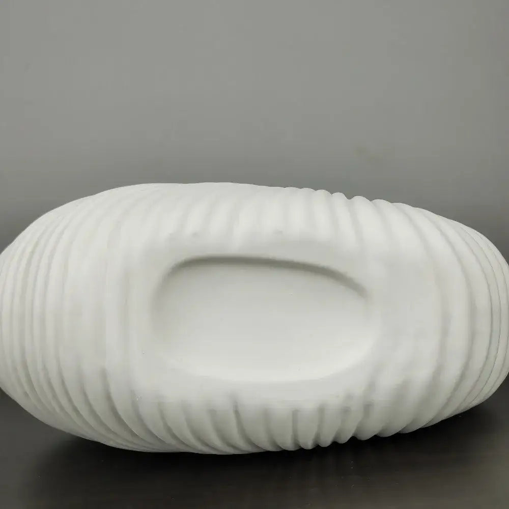 White ceramic elegant ceramic vase with shell conch design featuring ribbed texture and central recessed well