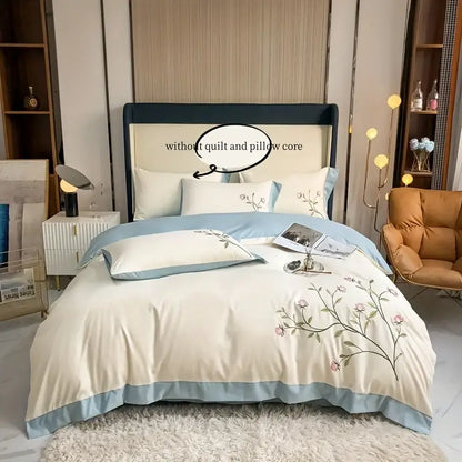 Cream-colored DecorBites elegant embroidery duvet cover set with pink and green floral embroidery and blue piping edges