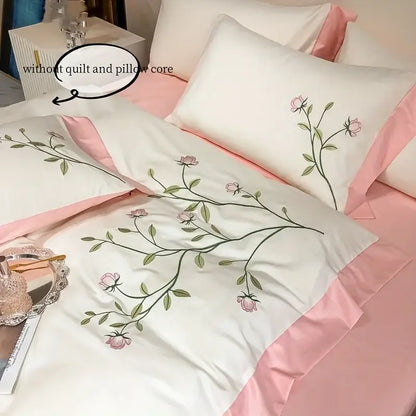 White satin pillowcases with delicate pink rose embroidery and matching pink satin piping in decorbites™ elegant embroidery duvet cover set blue pink