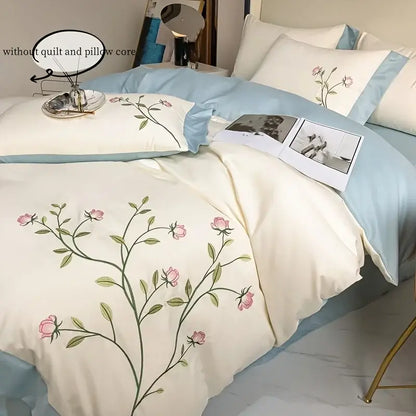 Cream-colored DecorBites™ duvet cover with elegant pink rose embroidery and light blue piping 3-piece set
