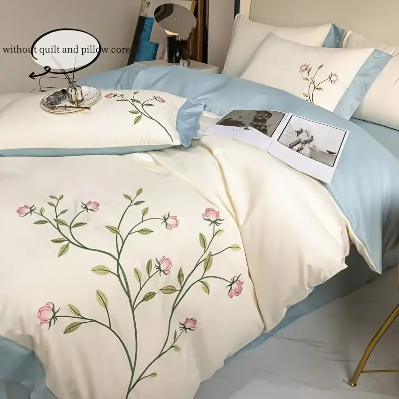 Cream-colored DecorBites™ duvet cover with elegant pink rose embroidery and light blue piping 3-piece set
